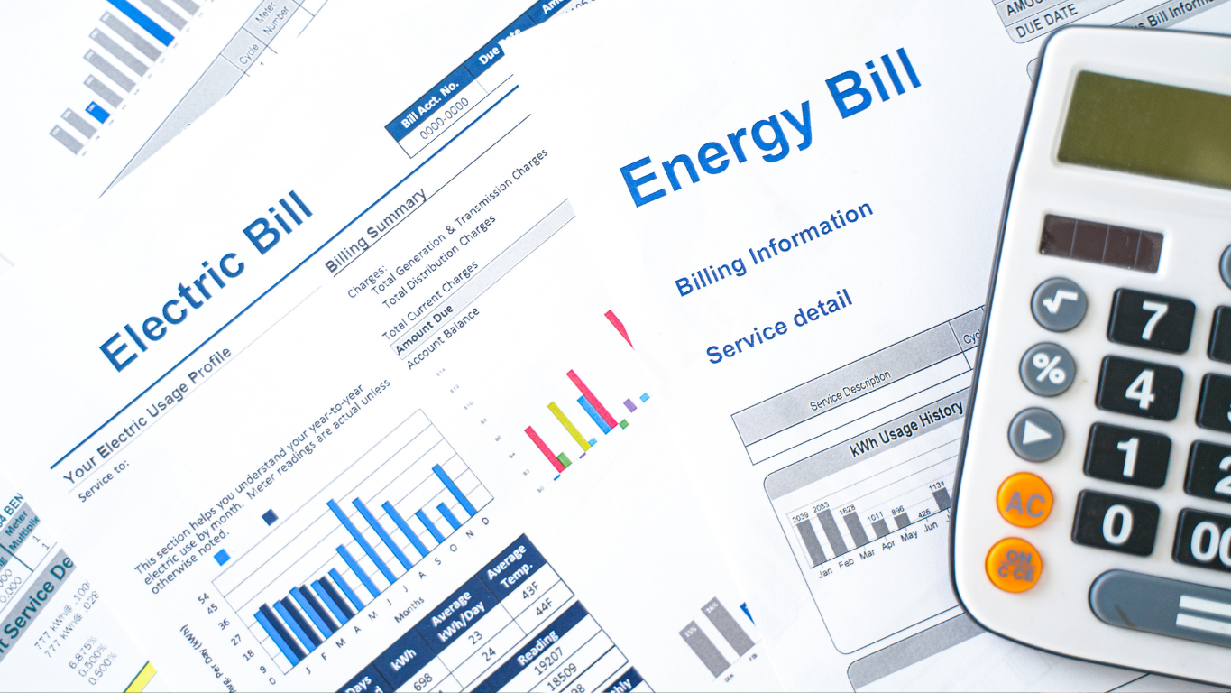 A calculator next to high electric bills and energy usage charts, illustrating the cost of an inefficient air conditioning system.