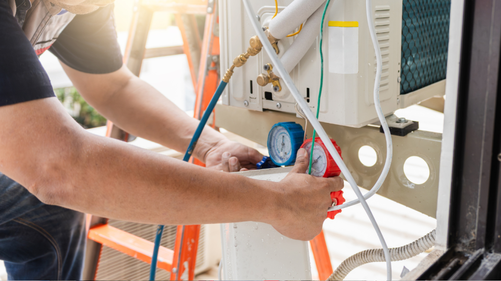 A professional HVAC technician using manifold gauges to check refrigerant levels and test for leaks on an outdoor air conditioning unit.