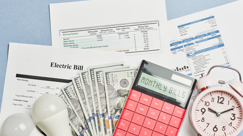 A red calculator displaying 'MONTHLY BILLS' surrounded by cash and high electric bills, symbolizing the high cost of a poorly maintained A/C unit.
